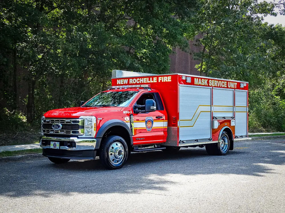 Front-left three-quarter exterior view of the red mask service unit truck.