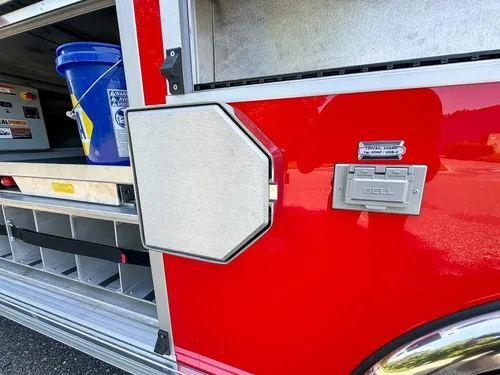 Small side hatch closed near mid-body compartment area.