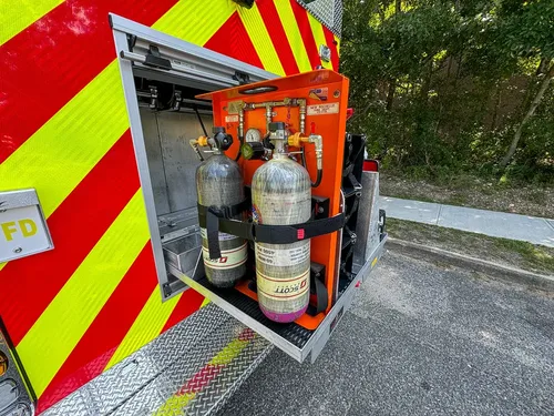 Rear compartment with multiple SCBA cylinders secured in rack.