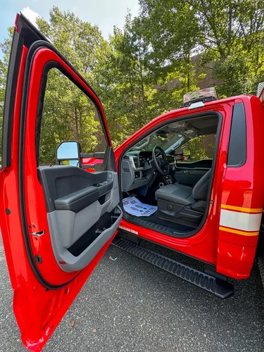 Open driver door view showing front seat and dash entry.