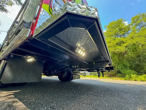 Low underside view with side awning/door panel raised overhead.