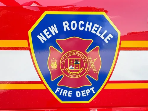 Door emblem close-up with New Rochelle Fire Department crest.