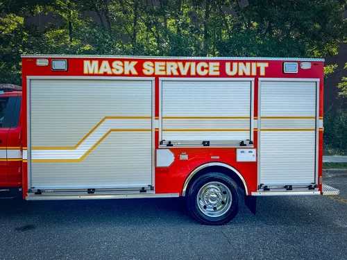Right-side body view with roll-up doors and service unit lettering.