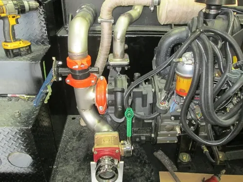 Exterior view of small fire truck showing cab, body compartments, and wheel/tire area.