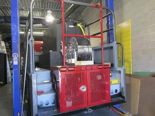 Exterior view of small fire truck showing cab, body compartments, and wheel/tire area.