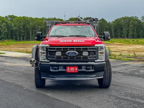 Driver-side profile of red brush truck, photo 3 of 179.