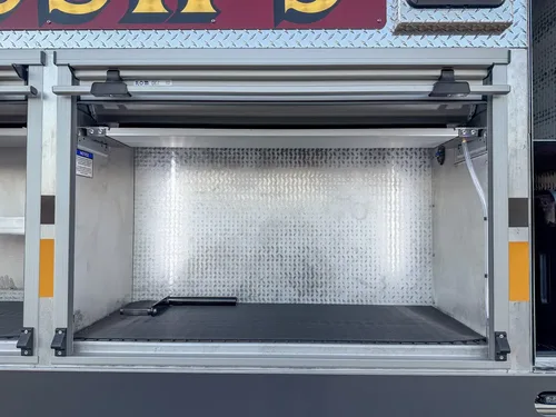 Open side shelf compartment above rear wheel area.