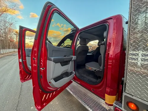 Rear door open with view into second-row seating area.
