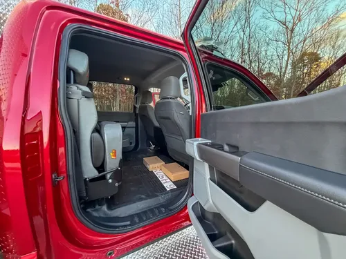 Open rear door with second-row seats and floor area.
