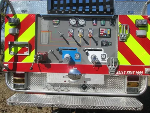 Exterior view of small fire truck showing cab, body compartments, and wheel/tire area.