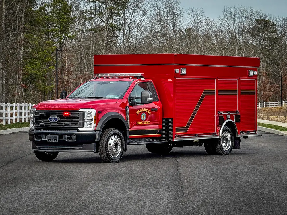 Front-left exterior view of red BRAT truck parked on pavement.