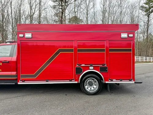 Close side view of right body compartments and rear wheel area.