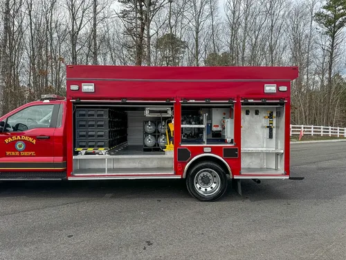 Right-side compartment bay opened, showing storage and equipment.