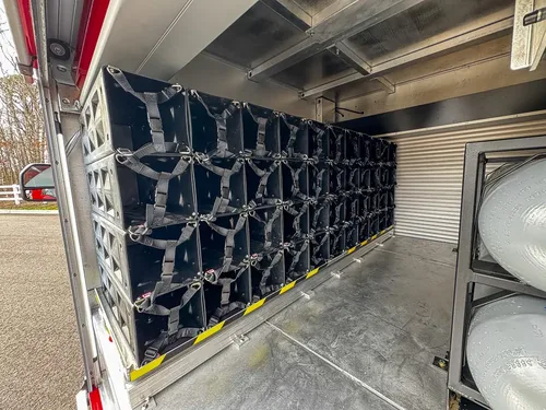 Slide-out bottle carrier rack extended from side compartment.