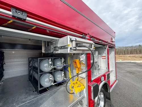 Side compartment with extended rack, air cylinders, and nearby shelving.