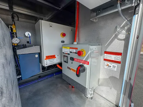 Close view of electrical control boxes and disconnects in equipment bay.