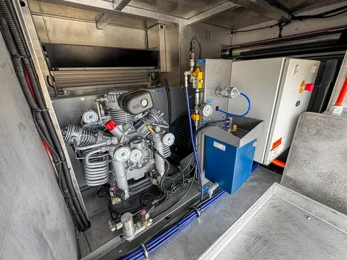 Compressor and support equipment mounted inside side compartment.