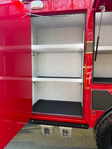 Close-up of vertical side compartment with three shelves.