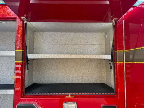 Close-up of center side compartment with upper shelf and rubberized floor.