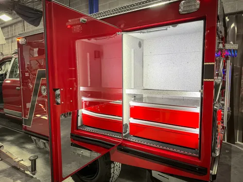 Open rear side compartment with slide-out red drawers and upper shelf.