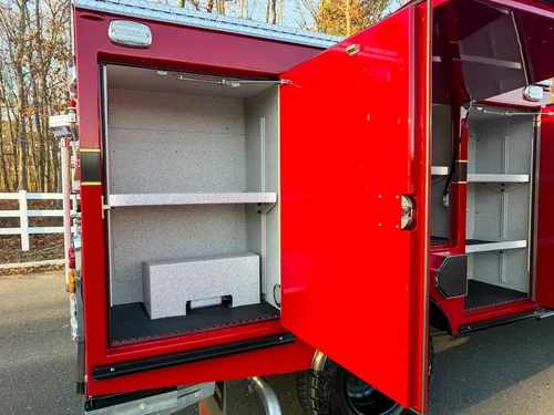 Close-up of rear left compartment with shelf and lower storage block.