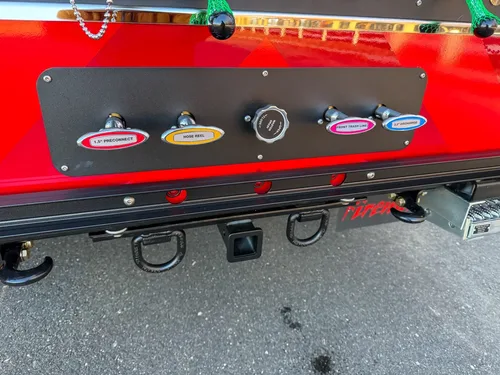 Lower rear control strip with labeled valve handles and center cap.