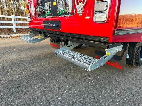 Rear view with both slide-out steps deployed on each side.