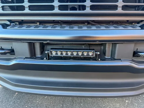 Close-up of recessed LED light bar mounted in the front bumper.