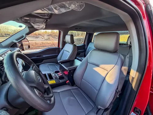 Interior view across both front seats with center console controls visible.
