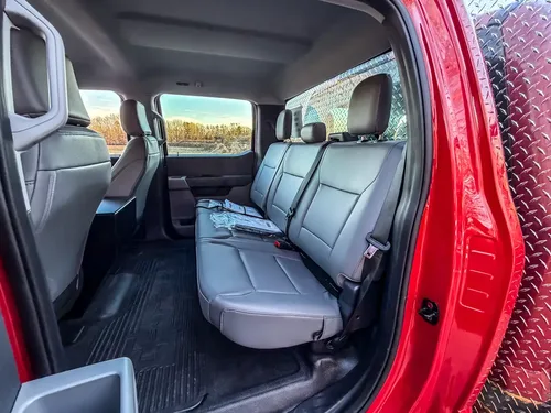 Rear cabin view showing full-width bench seat and rear floor area.