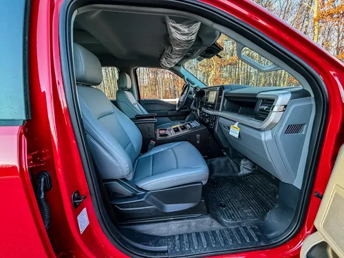 Passenger-side interior view with front seat, dashboard, and center console.