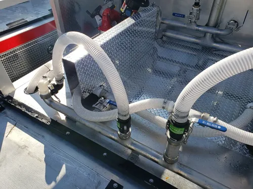 Exterior view of small fire truck showing cab, body compartments, and wheel/tire area.
