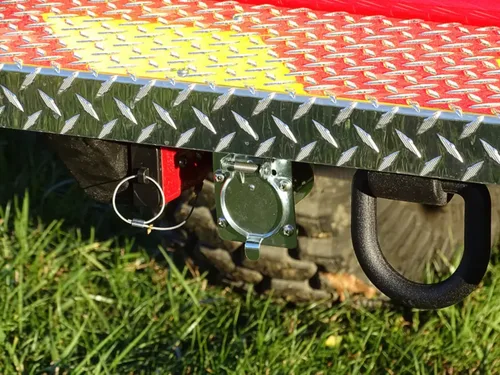 Exterior view of small fire truck showing cab, body compartments, and wheel/tire area.