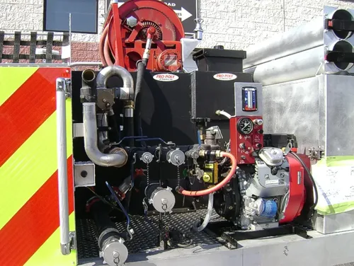 Exterior view of small fire truck showing cab, body compartments, and wheel/tire area.