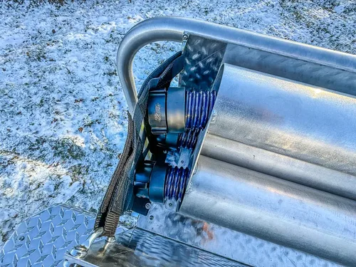 Rear upper-body close-up showing rolled hose compartment and mounted wiring.