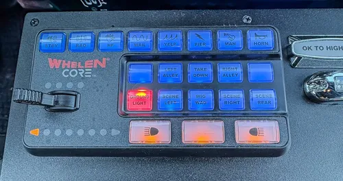 Close-up of Whelen control keypad and illuminated switch panel.
