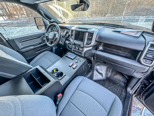 Angled front interior view showing center console, dashboard, and steering wheel.
