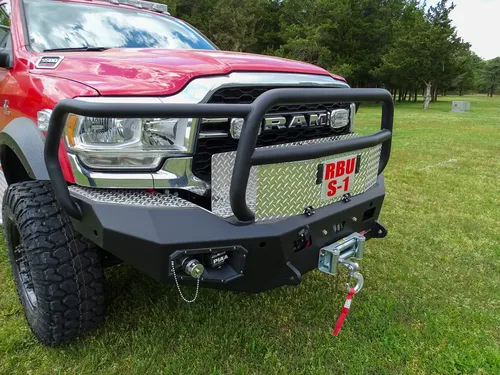 Exterior view of small fire truck showing cab, body compartments, and wheel/tire area.