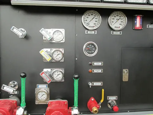Exterior view of small fire truck showing cab, body compartments, and wheel/tire area.