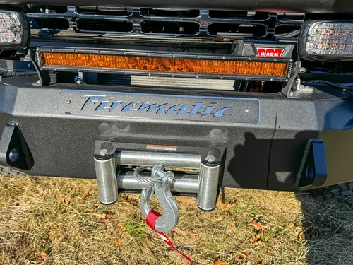 Lower front bumper close-up with winch fairlead and tow points.