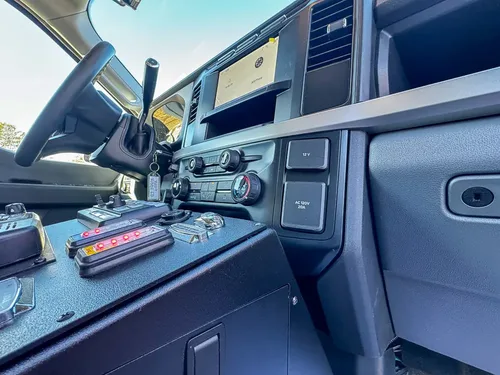 Front center console close-up with radios, control knobs, and dashboard switches.
