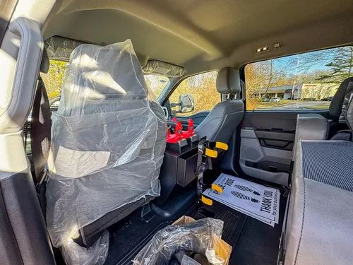 Rear seating area view with seatbacks, center console, and floor mats.