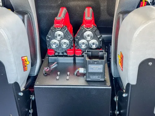 Center rear console close-up with mounted red controls between seats.