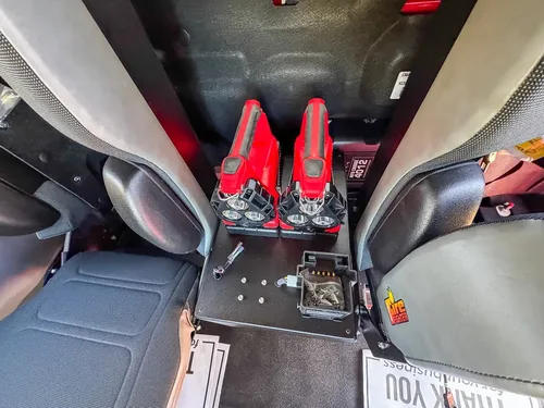 Close-up of center rear console with dual red control handles.