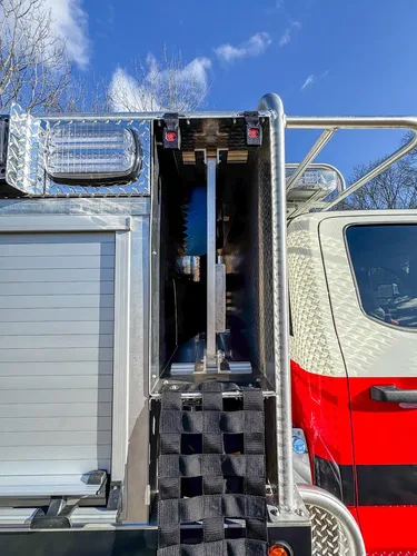Open narrow vertical side compartment beside the roll-up body door.
