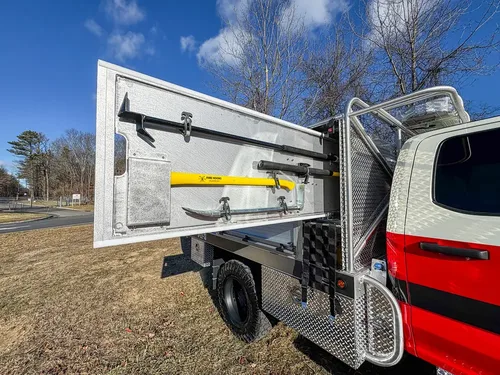 Open side door with a mounted yellow securing strap on the interior panel.