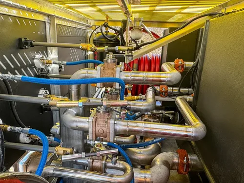 Close-up inside the pump area with valves, pipes, and control components.