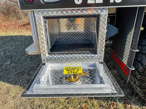 Open lower side compartment with fold-down tray and empty interior.