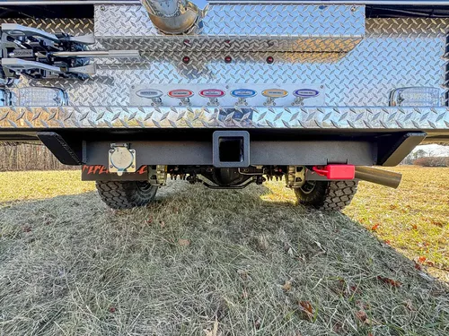Rear underside view showing hitch receiver and trailer wiring connector.