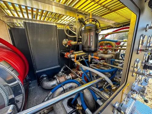 Pump compartment interior showing hoses, valves, and piping.